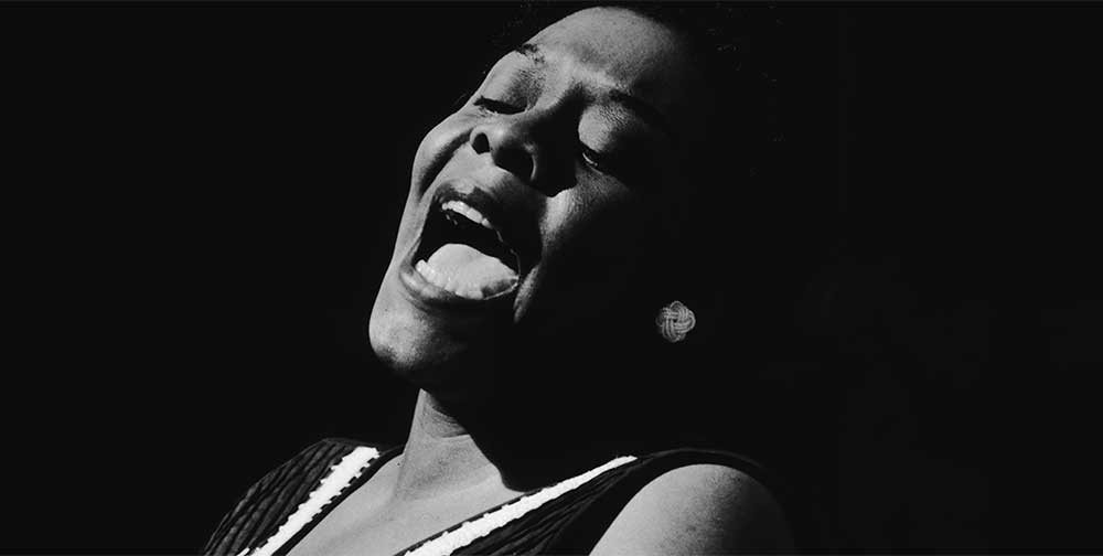 Black and white portrait of Dinah Washington singing